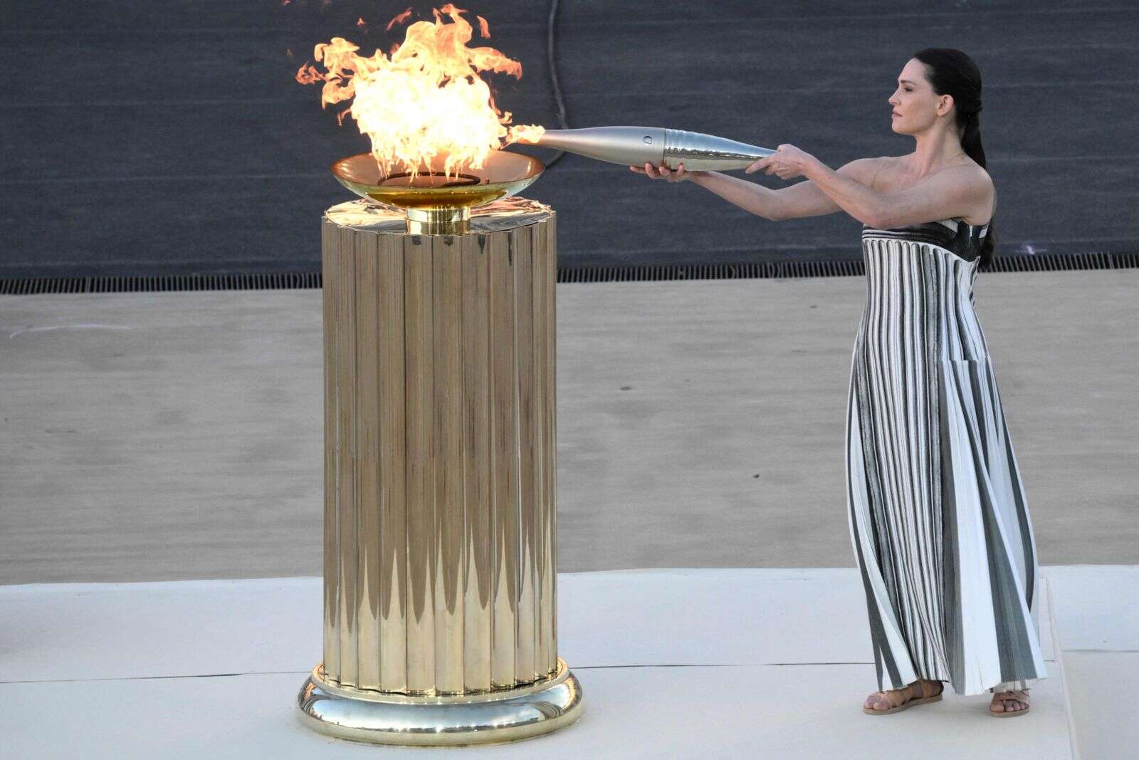 poignant ceremony as greece hands over olympic torch for 2024 games to hosts paris