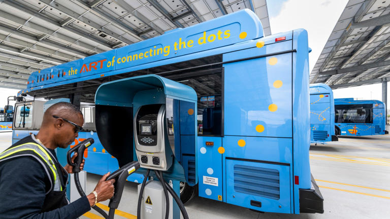Safety Manager Anthony Hill, with the Anaheim Transportation Network, demonstrates a bus charging terminal in Anaheim, CA on Wednesday, April 24, 2024. ATN opened a solar-powered EV charging hub for its fleet of 80 battery electric buses.