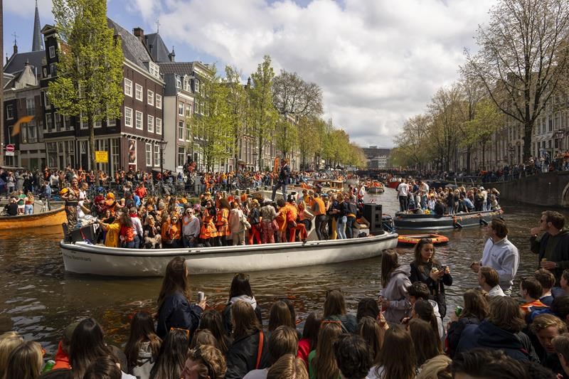 orange crush: boats packed with revelers tour amsterdam canals to celebrate the king's birthday