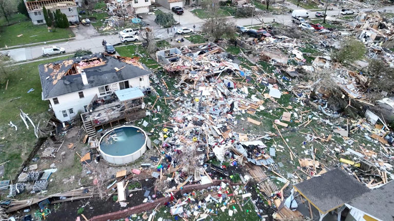 A drone view shows people inspecting the site of damaged buildings in the aftermath of a tornado in Omaha on Friday. (Alex Freed via Reuters)