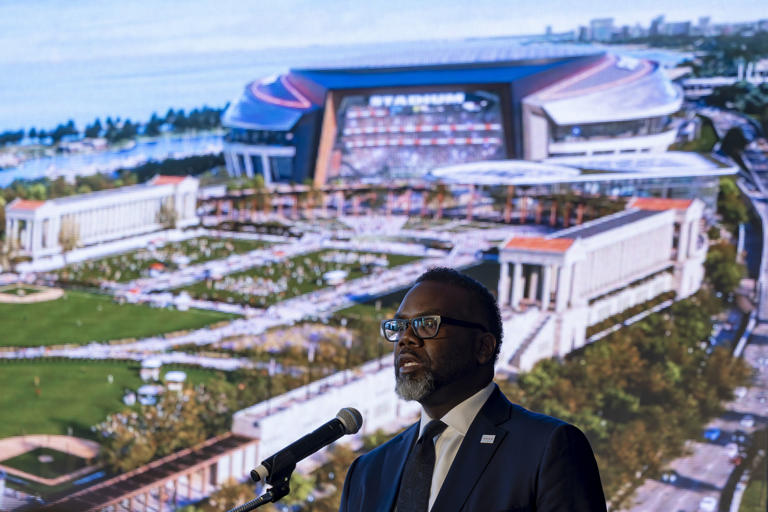 Mayor Brandon Johnson in front of an artist's rendering as the Bears announce plans to build a new lakefront domed stadium, April 24, 2024.