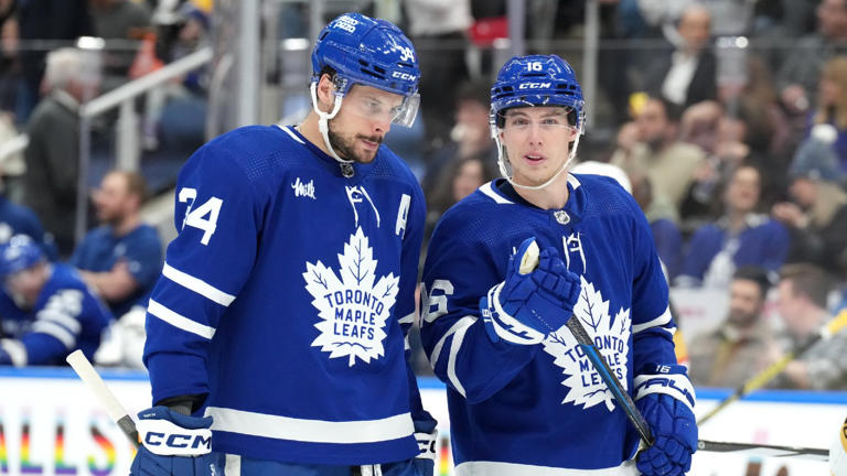 Toronto Maple Leafs’ Auston Matthews, left, talks with Mitch Marner