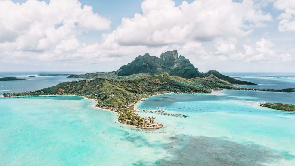 <p>Bora Bora is one of the world’s most luxurious<a href="https://worldwildschooling.com/underrated-tropical-vacation-destinations/"> tropical vacation destinations</a>, so it’s no surprise that the island’s main beach, Matira Beach, makes this list. If you’ve always dreamt of waking up in an overwater bungalow, looking out over tropical crystal-clear waters, and diving into the sea, Matira Beach is the place for you.</p><p>Offering impressive views of Bora Bora’s iconic mountain landscape, this white-sand beach is lined with palm trees, providing protection from the 86°F (30°C) May temperatures. It has many <a href="https://worldwildschooling.com/colorful-coral-reefs-for-snorkeling/">coral reefs to explore</a>, and there are even charming local bars on the sand. We can picture you with a cocktail in hand on the beach already!</p><p class="has-text-align-center has-medium-font-size">Read also: <a href="https://worldwildschooling.com/hidden-beaches-in-the-world/">Best Hidden Beaches in the World</a></p>