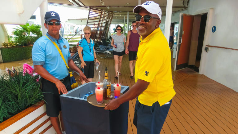 A waiter serves drinks on a Royal Caribbean ship. Royal Caribbean DB 033023 LEAD