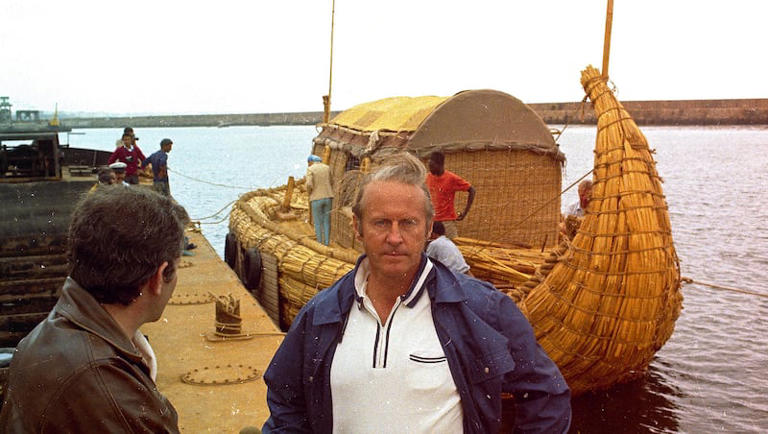Norwegian explorer Thor Heyerdahl is seen in front of his papyrus boat, Ra, in 1969 in Safi, Morocco, as he prepared to take the craft across the Atlantic to the Americas.