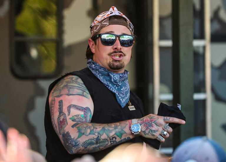 Hardy throws merchandise out into the crowd before a cooking demonstration with Guy Fieri and Bailey Zimmerman at Guy Fieri's Smokehouse during Stagecoach country music festival in Indio, Calif., Sunday, April 28, 2024.
