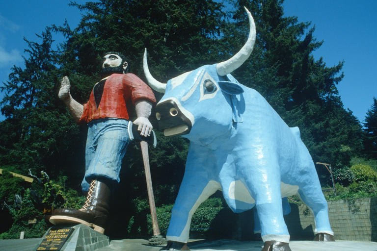 A 49- foot tall Paul Bunyan and his sidekick, Babe the Blue Ox, await visitors in the parking lot of Klamath’ s vintage Trees of Mystery park.