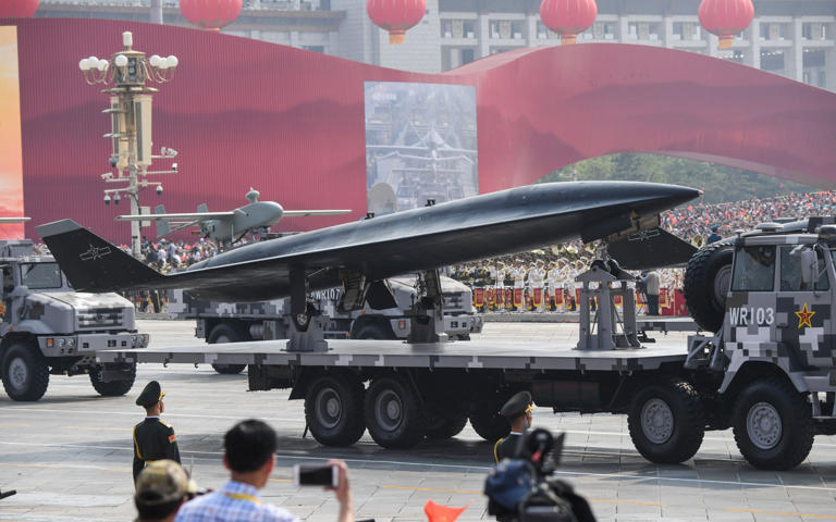 A military vehicle carrying a WZ-8 supersonic reconnaissance drone takes part a military parade at Tiananmen Square in 2019. The drone may now have been photographed in flight, carried under a heavy bomber - Greg Baker/AFP via Getty