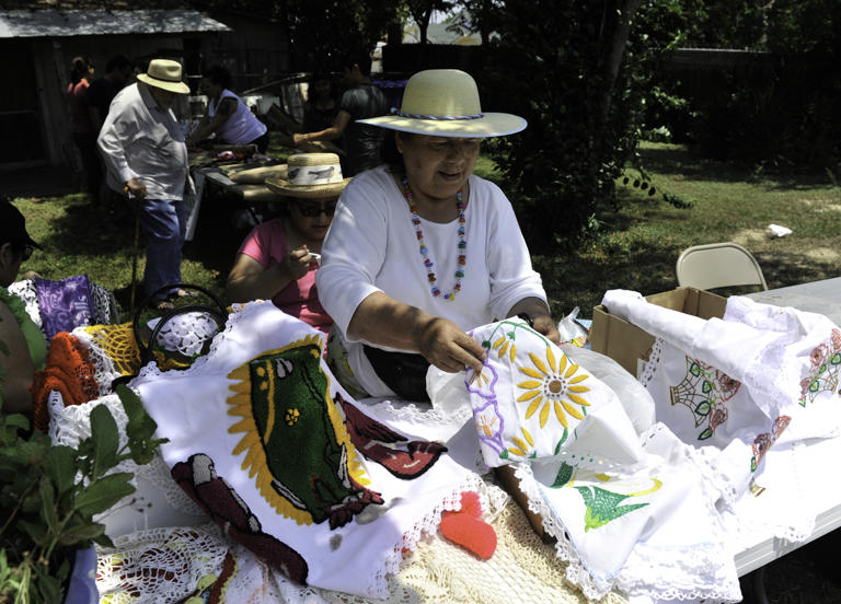 Rosa Garcia sorts Mexican dish towels during the Paseo por el Westside Festival in 2012.
