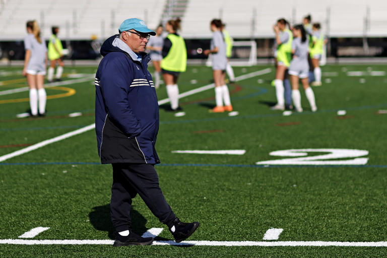 First Colonial girl soccer coach Joe Tucei high watches his team warm up before the game against Ocean Lakes at Ocean Lakes High School in Virginia Beach, Va., March 16, 2024. Tucei has just hit the 400 win mark.