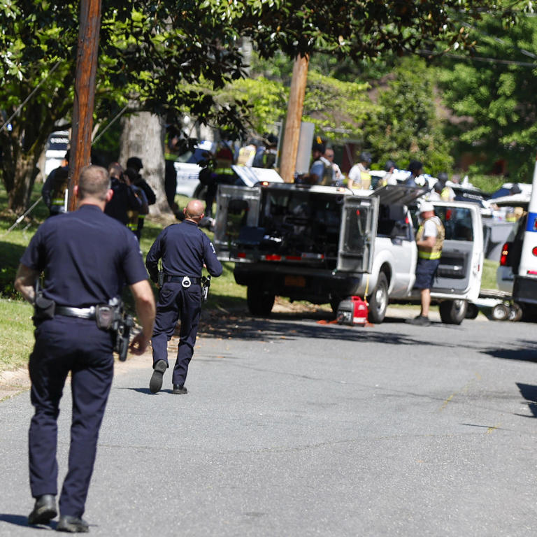 Officers with the Charlotte-Mecklenburg Police Department work in the neighborhood where a shooting took place in Charlotte, North Carolina, April 29, 2024.