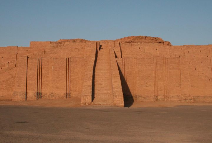 <p>The Ziggurat of Ur, located in modern-day Dhi Qar Province, Iraq, is a majestic remnant of the Mesopotamian city of Ur. Construction of the Ziggurat of Ur began during the Early Bronze Age, making it one of the oldest standing structures in the world. It was built by King Ur-Nammu of the Third Dynasty of Ur and was devoted to the moon god Nanna, the city’s patron deity. While partially crumbled by the 6th century BCE, King Nabonidus restored it during the Neo-Babylonian period. Unlike the smooth-sided pyramids of Egypt, ziggurats are tiered pyramid temples with a rectangular or square foundation.</p>