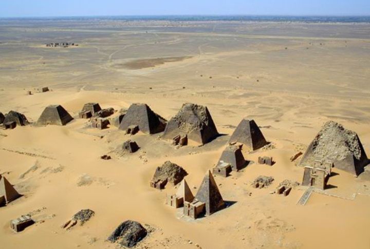<p>The Nubian pyramids, scattered across the desert sands of Sudan, are a collection of often-overlooked yet impressive ancient structures. They were constructed by the Kushite kings and queens who ruled the powerful Kushite Kingdom. Nubian pyramids are generally much smaller than their Egyptian counterparts. They range in height from about 6 meters (20 feet) to around 30 meters (100 feet), with most falling on the lower end of that spectrum. Over 200 Nubian pyramids are spread across several sites in northern Sudan, with the most significant concentrations being Meroë, El-Kurru, and Nuri. Twenty-one kings and fifty-two queens are buried in the pyramids in Nuri.</p>