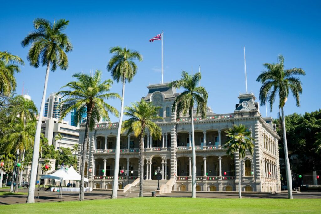 <p>Iolani Palace is the only American castle to actually house a royal family and serve as a royal residence. Built in 1882 by King Kalakaua, it was the home of Hawaii’s last reigning monarchs until the overthrow of the monarchy in 1893. Iolani Palace is the hallmark of Hawaiian renaissance architecture, a rebirth of traditional Roman architectural principles of aesthetics with concepts derived from Hawaiiana. Its crenelated parapets and towers resemble a medieval castle, but it symbolizes the Hawaiian spirit.</p>