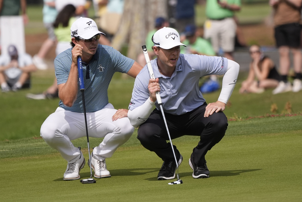 <p>Nico Echavarria, of Colombia, and teammate Max Greyserman study their shot on the 17th green during the final round of the PGA Zurich Classic golf tournament at TPC Louisiana in Avondale, La., Sunday, April 28, 2024. </p>
