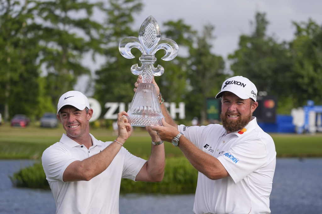 <p>Rory McIlroy, of Northern Ireland, and teammate Shane Lowry, of Ireland, right hold up their trophy after winning the PGA Zurich Classic golf tournament at TPC Louisiana in Avondale, La., Sunday, April 28, 2024. </p>