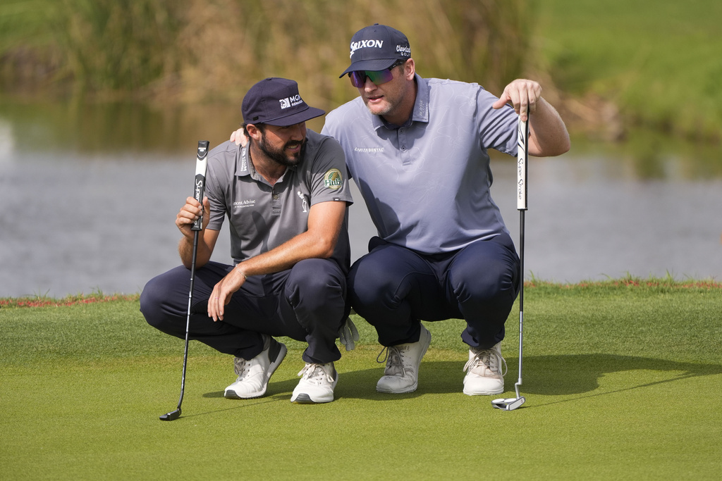 <p>Ryan Brehm, right and teammate Mark Hubbard discuss their next shot on the 17th green during the final round of the PGA Zurich Classic golf tournament at TPC Louisiana in Avondale, La., Sunday, April 28, 2024. </p>