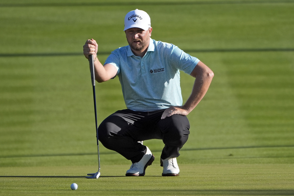 <p>Brice Garnett checks his line on the second hole during the first round of The Players Championship golf tournament Thursday, March 14, 2024, in Ponte Vedra Beach, Fla. </p>