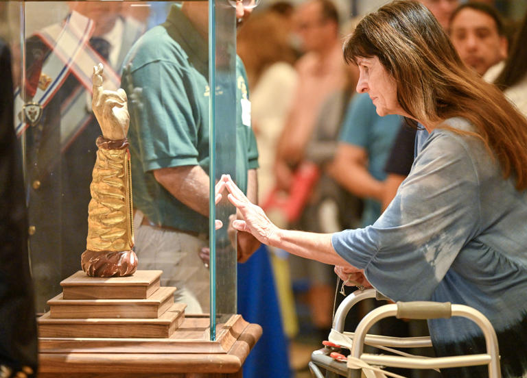 Lake Forest, CA – April 29: Theresa Sniadowski pauses while visiting the relic of St. Jude Thaddeus on display at Santiago de Compostela Catholic Church in Lake Forest, CA, on Monday, April 29, 2024. The relic of St. Jude, a bone from his arm, is normally housed at a Roman parish near Vatican City. It’s currently making its way through Orange County as part of a national tour of more than 100 cities. (Photo by Jeff Gritchen/MediaNews Group/Orange County Register via Getty Images)
