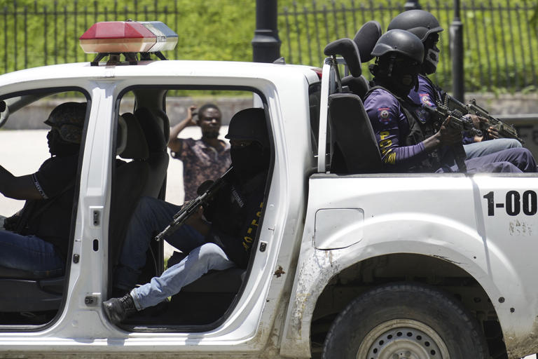 Police patrol near the National Palace amid the sound of gunshots in the distance in Port-au-Prince, Haiti, Tuesday, April 30, 2024. (AP Photo/Ramon Espinosa)