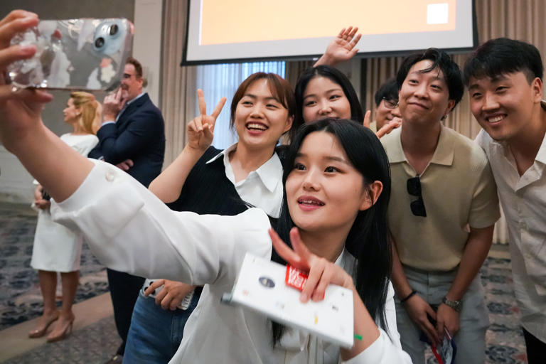 Lily Jo takes a selfie with fellow North Korean refugees Grace Kang, left, and Bella Ha alongside event guests after speaking during the "A Path to Peace: The Hopeful Hearts of North Korea" event at SMU on Monday, April 29, 2024.