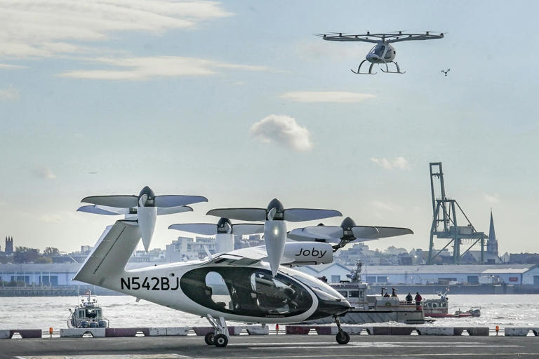 Joby, on the helipad, and Volocopter, in the air, demonstrated their eVTOLs in New York in November 2023. Volocopter hopes to fly demonstrations of its VoloCity air taxi at the 2024 Paris Olympics.