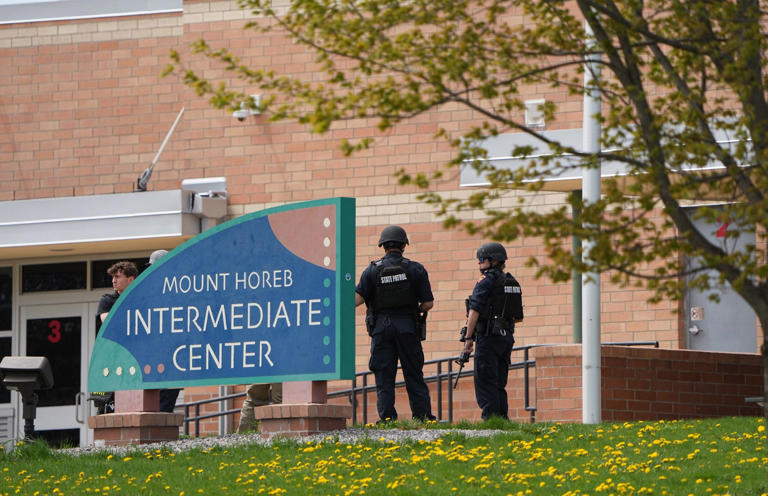 Law enforcement officers stand outside the Mount Horeb Intermediate Center in Mount Horeb, Wisconsin on Wednesday, May 1, 2024.