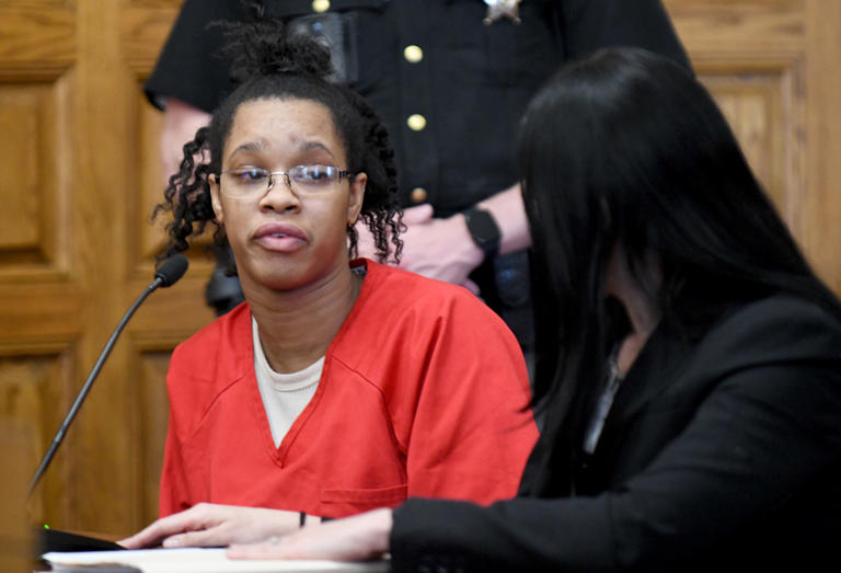 Chabrijuana J. Glenn, left, is shown with defense attorney Tiffany Poirier as she speaks to the family of Douglas G. Adkins in Stark County Common Pleas Court on Wednesday. Judge Natalie R. Haupt sentenced Glenn to 23 years to life in prison for killing the Canton man.
