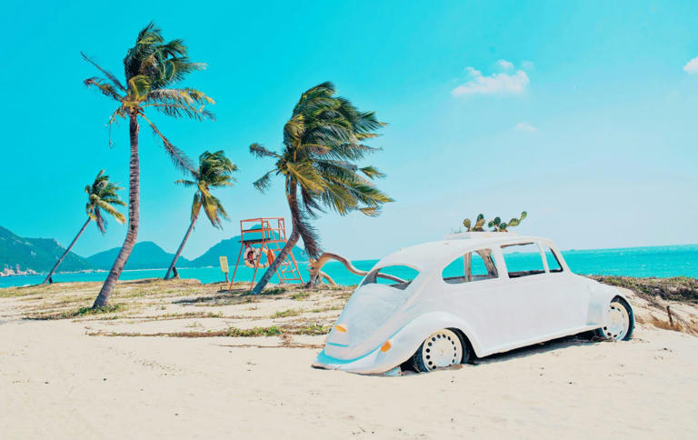 These destinations are some of the cheapest places to visit in June, learn why they are top option. Pictured: a windy beach with a Volkswagen and bright blue skies