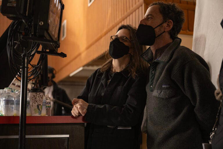 (L TO R) Writer/producer Tricia Cooke and director/writer/producer Ethan Coen on the set of DRIVE-AWAY DOLLS, a Focus Features release. Credit: Wilson Webb / Working Title / Focus Features