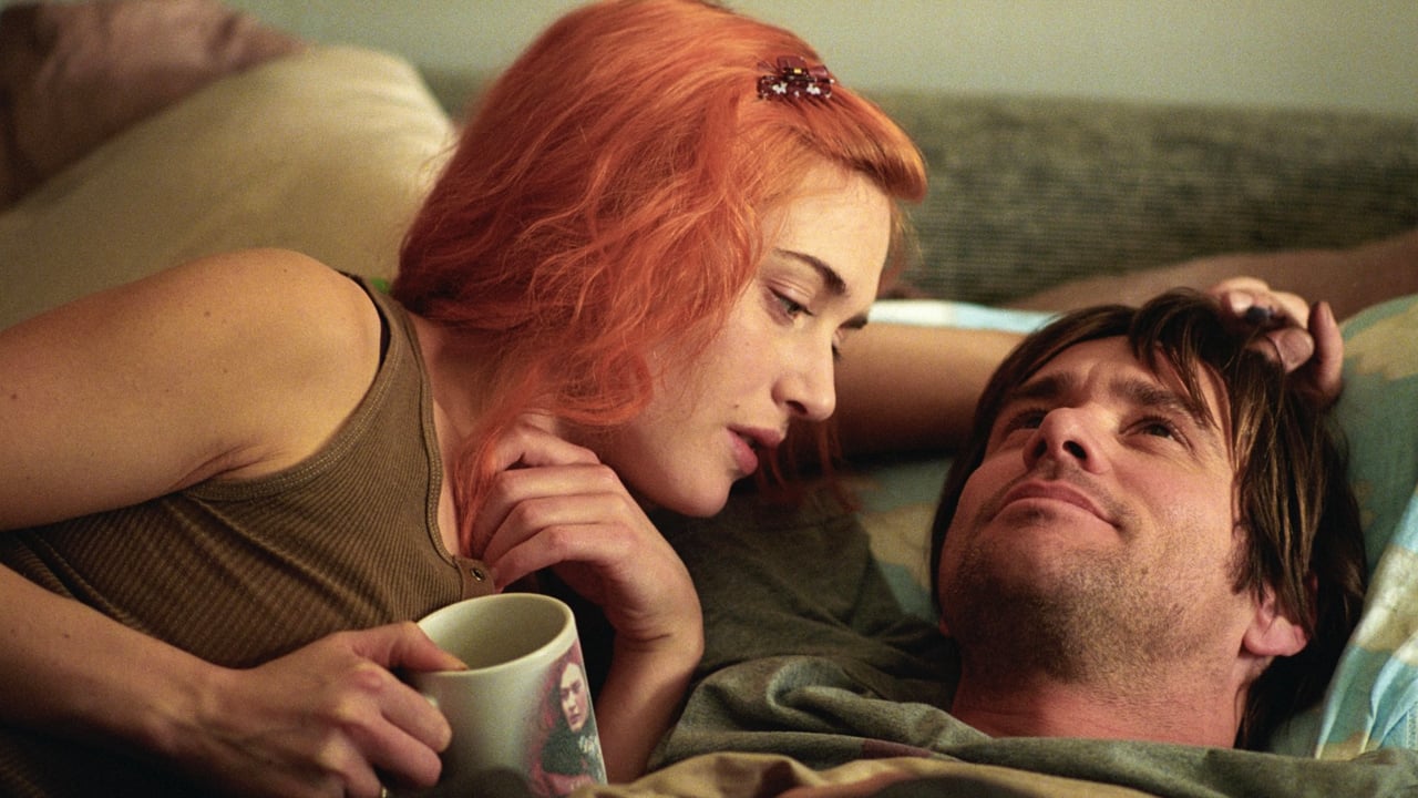 <p>Dazzling, heartbreaking, and wholly original, <a href="https://wealthofgeeks.com/healing-heartbreak-25-movies-to-watch-after-being-cheated-on/"><em>Eternal Sunshine of the Spotless Mind</em></a> follows a man who discovers his girlfriend has a procedure that erases all memories of him. Hurt by her actions, he decides to do the same until his consciousness regrets the decision.</p><p>Most cinematic love stories follow familiar tropes and characterizations, but <em>Eternal Sunshine’s</em> unconventional approach creates something entirely different. The supporting cast of Tom Wilkinson, Elijah Wood, Mark Ruffalo, and Kirsten Dunst excels.</p><p>But the film belongs to Jim Carrey and Kate Winslet, whose chemistry balances chaos and peace, demonstrating endless joyous, somber, heartfelt, and emotional moments. <em>Eternal Sunshine’s</em> glimpse into the mystery of memories and the power of fate creates one of the finest of the modern era.</p>