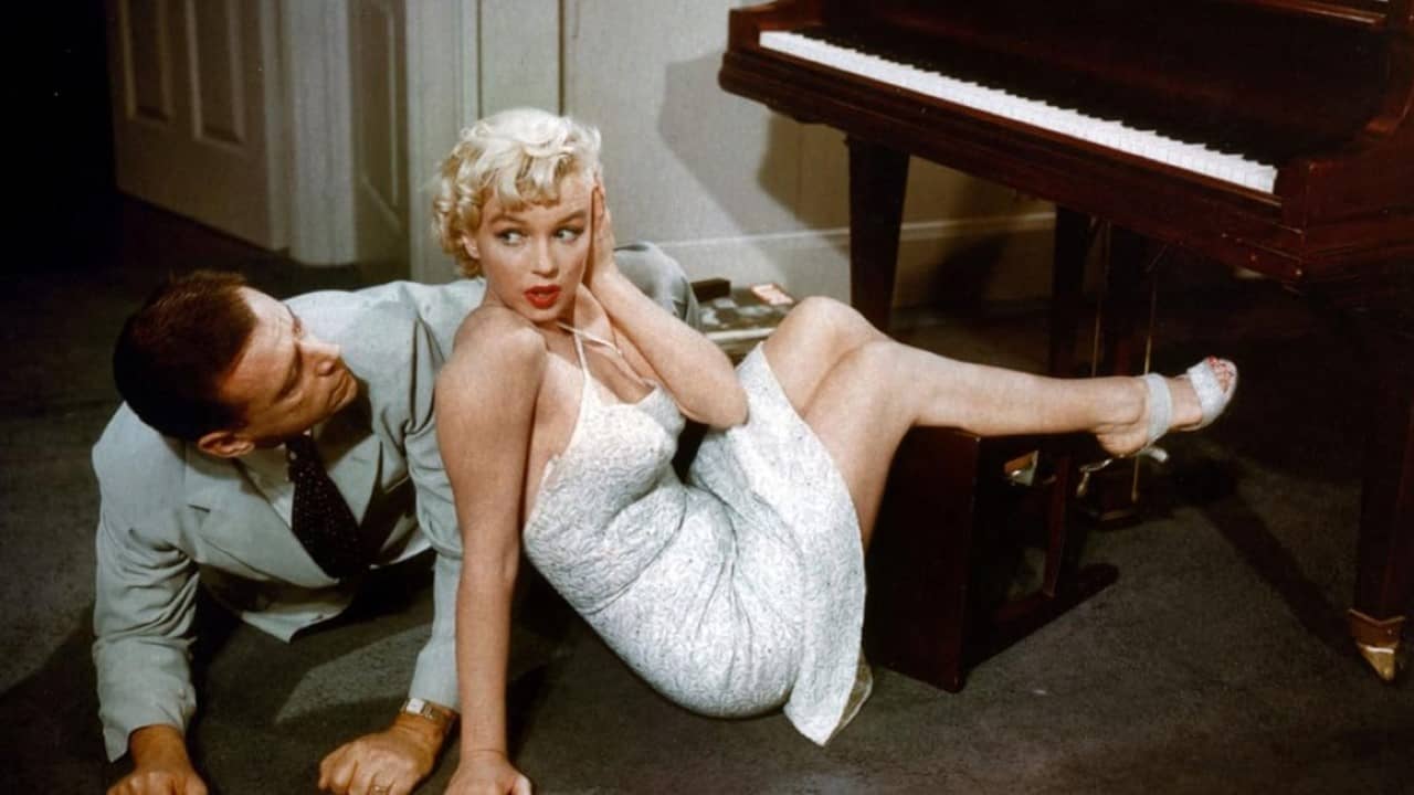<p>Wilder directed one of Marilyn Monroe’s most iconic moments in his adaptation of George Axelrod’s stage comedy <em>The Seven Year Itch</em>. The story follows New Yorker Richard Sherman, who longs to return to his bachelor ways when his family leaves on their annual summer vacation. But soon, his ditzy, beautiful neighbor tempts his amorous and overactive imagination. Monroe’s famous moment comes midway through the movie when the cool air from a subway grate blows up her white skirt as Sherman delightedly watches.</p><p><em>The Seven Year Itch</em> has not aged well since its 1955 release, but this remains one of Monroe’s best comedic roles. Despite her difficulties on set, Wilder was one of the few directors who could channel her singular persona to great effect. Character actor Tom Ewell deserves mention too, playing his daffy family man like a deer in the headlights when facing the stunning Monroe.</p>