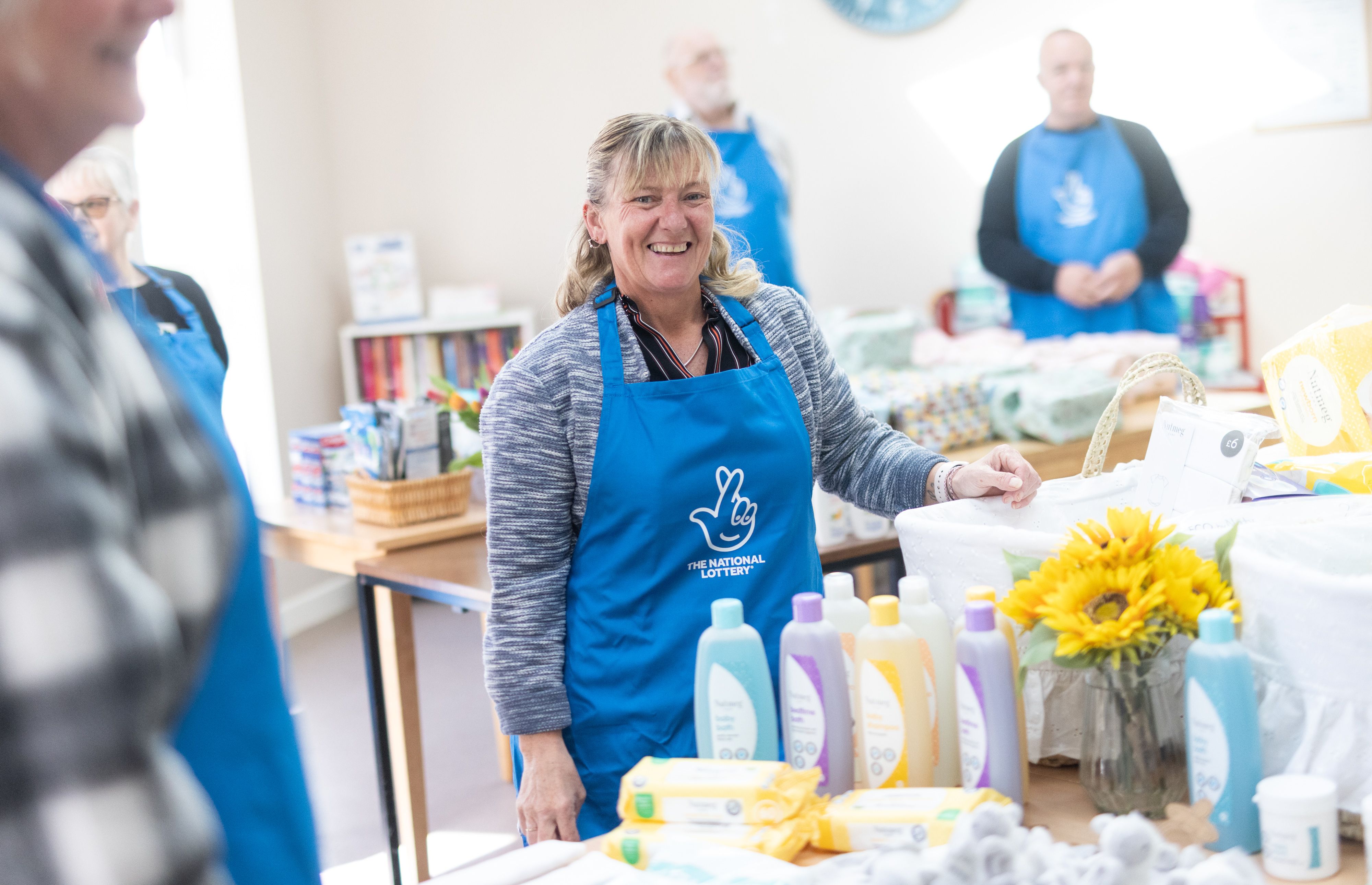 team of lottery winners lend a hand at baby basics charity