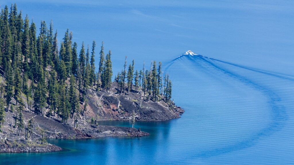<p>There are no private boats allowed on Crater Lake, so the only way to get around is by tour boat. These two-hour tours take you past sights like Wizard Island and the Phantom Ship and along the base of the rim, offering a unique perspective not found from the top of the rim drive.</p><p>The trail to the boat dock is not for the faint of heart. It is 2.2 miles long and drops 760 feet to the lake.</p>