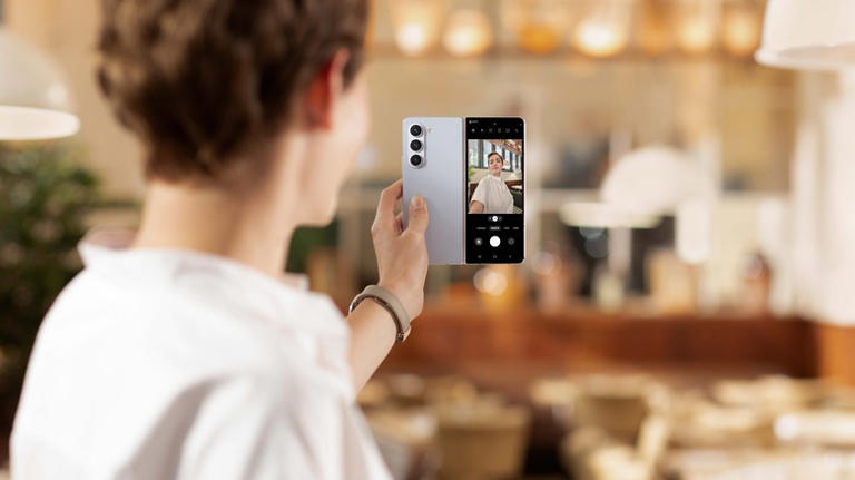 Woman using selfie mode on Samsung Galaxy Z Fold 5