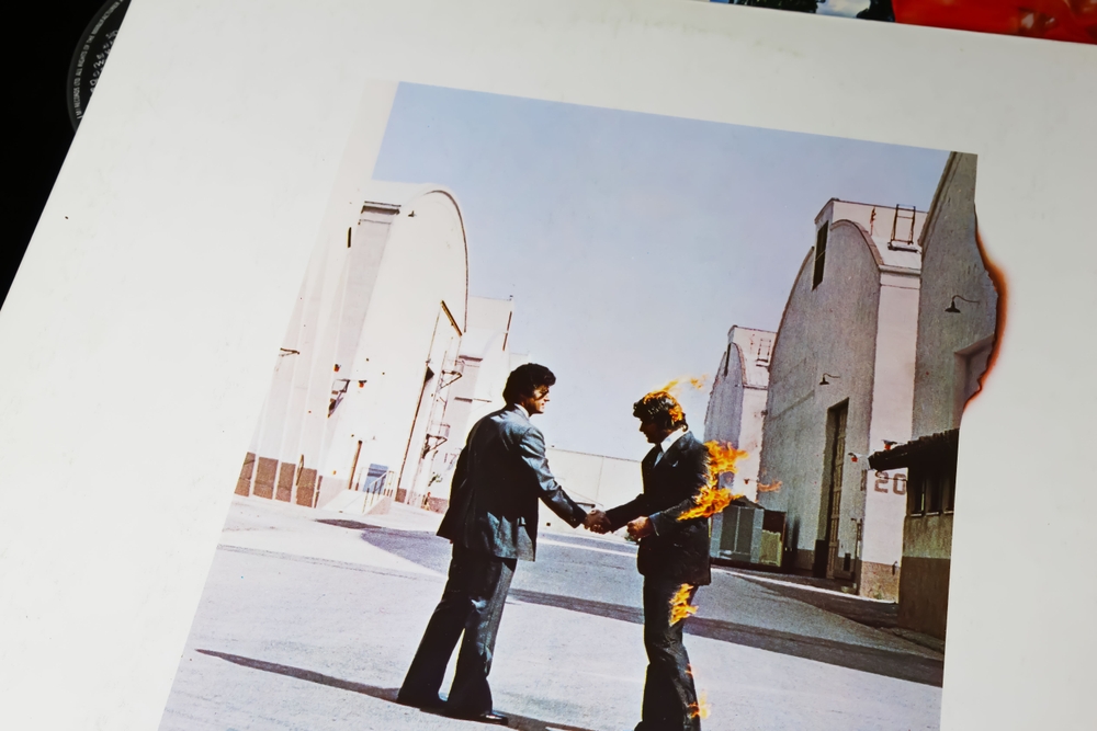 With its legendary man-on-fire album cover and vast, lush songs that are endlessly on repeat, Pink Floyd's <em>Wish You Were Here</em> has been a musical enigma since its 1975 release. This album is a tribute to former bandmate Syd Barrett, whose mental decline resonated deeply within the band. The iconic title track has become an anthem for the feeling of missing someone, while "Shine On You Crazy Diamond" serves as a direct homage to Barrett, blending bluesy despair with progressive rock mastery.