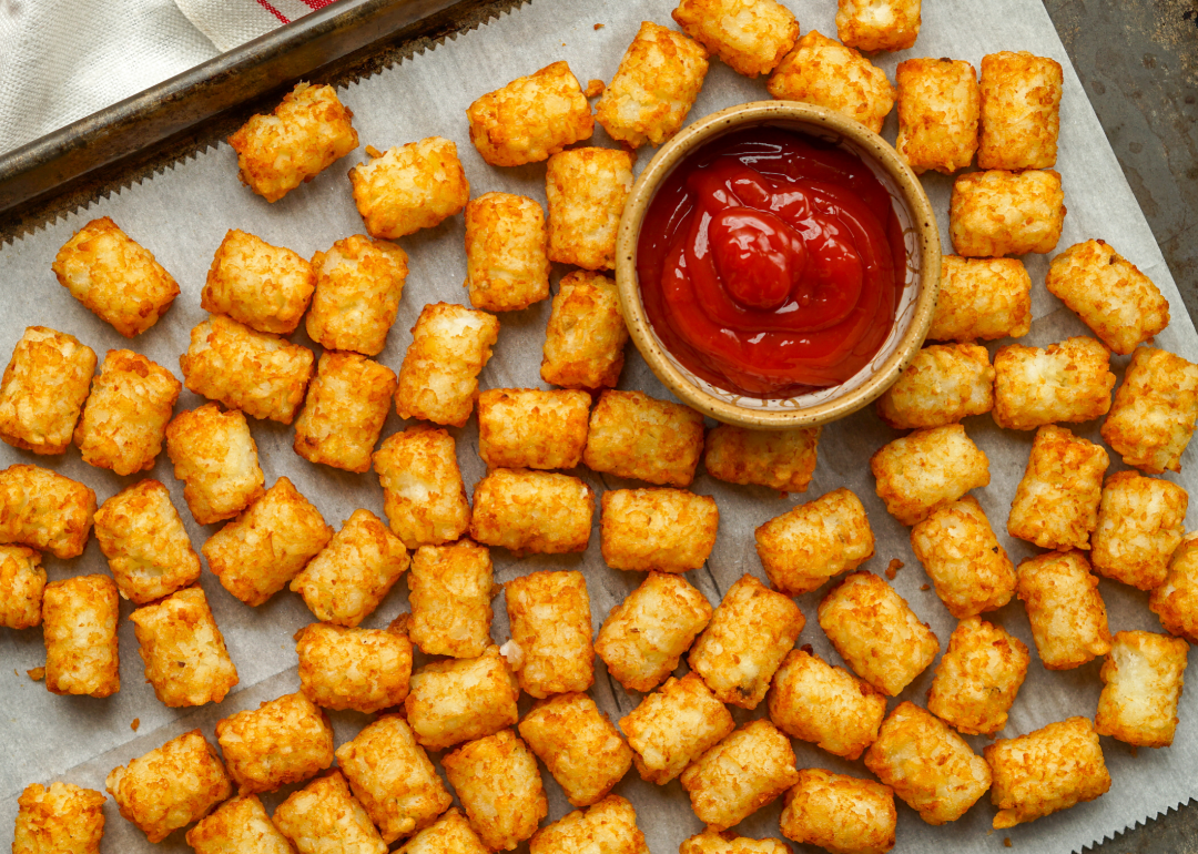 <p>Tater Tots—little, poppable fried clumps of potatoes—were <a href="https://www.eater.com/2017/8/28/16159710/tater-tots-ore-ida-history">first introduced</a> in 1954 by the founders of the American frozen food company Ore-Ida, F. Nephi and Golden Grigg. The crispy snack gained popularity due to its convenience and tastiness and has since been a staple of the American school cafeteria.</p>