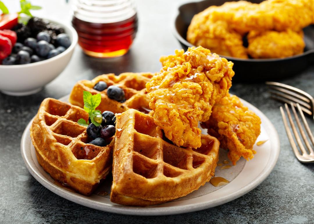 <p>While neither chicken nor waffles are specifically American delicacies, the combination of the two is very American. The dish pairs savory, crispy fried chicken with sweet and fluffy waffles, often with butter and syrup to boot, and is typically found in the American South. Some have speculated <a href="https://www.tastingtable.com/864678/the-mysterious-origin-of-chicken-and-waffles/">chicken and waffles</a> as a meal has roots in both Dutch and German, as well as African American cuisine.</p>