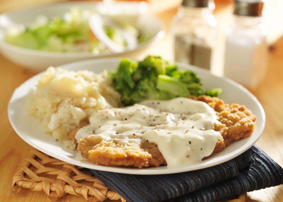 <p>Although this dish has roots and similarities to German and Austrian wiener schnitzel or Argentinian milanesa, people commonly identify chicken-fried steak with the American South. The dish, which doesn't include chicken at all, consists of a breaded and fried beefsteak, typically served with mashed potatoes and gravy.</p>