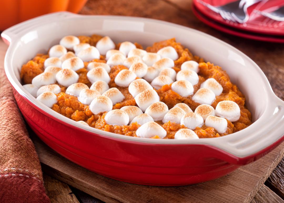 <p>It's either beloved or despised, but a sweet potato casserole will almost always be found at an American Thanksgiving dinner table. The recipe involves roasting sweetened sweet potatoes topped with a gooey layer of marshmallows and was <a href="https://www.vice.com/en/article/8qkp8v/sweet-potato-casserole-was-invented-by-the-marshmallow-industry">first introduced in 1917</a> thanks to the Angelus Marshmallows company's effort to increase sales.</p>