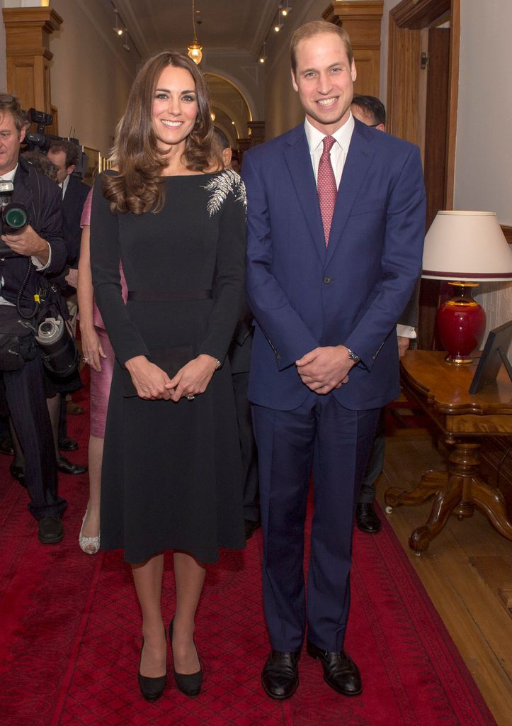 <p>The couple made a glamorous appearance as they attended an art unveiling of a portrait of Queen Elizabeth II by New Zealand artist Nick Cuthell at Government House in Wellington, New Zealand. William looked smart in a navy suit, while Kate paid tribute to her host country in a black bespoke Jenny Packham dress, which featured silver embroidered ferns – the national emblem of New Zealand.</p>