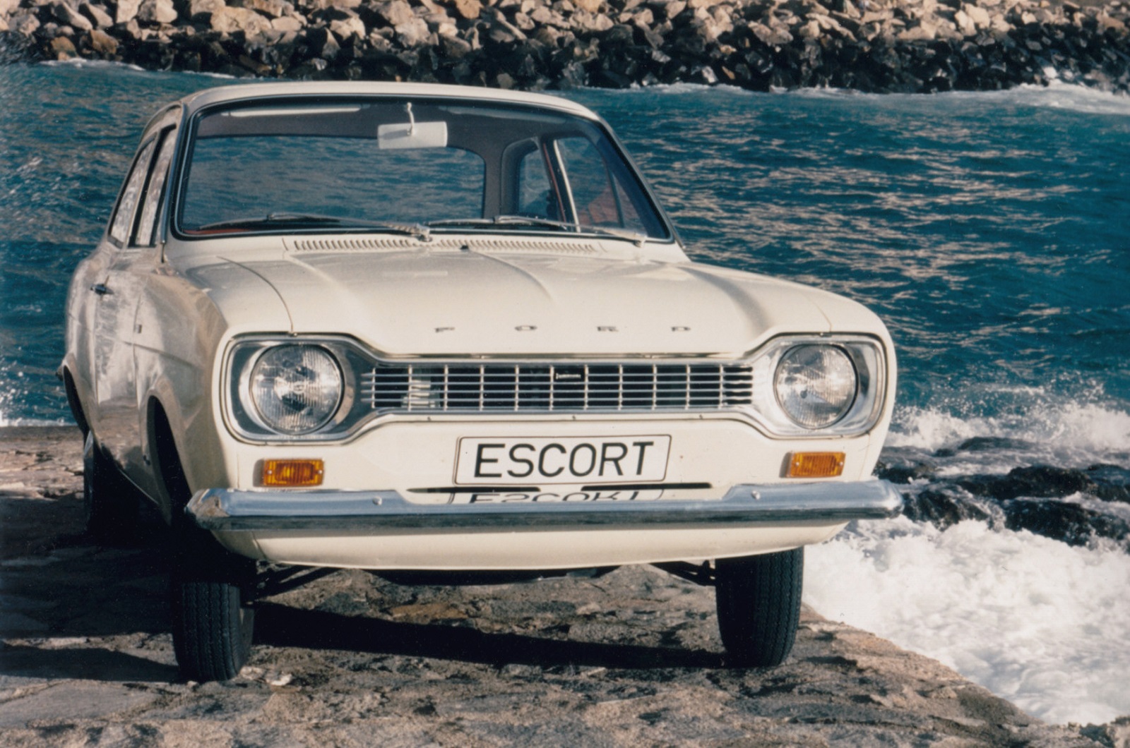 <p>Ford first used the Escort nameplate in <strong>1955</strong> on an estate variant of the Anglia 100E, but the designation didn’t denote a standalone model until <strong>1967</strong>. Launched to replace the Anglia, the first-generation Escort was a hugely significant car because it was developed by Ford of Europe, rather than by its British or its German division. It was built in both countries with minor market-specific differences starting in <strong>1968</strong>.</p><p>The original Escort range covered a stunningly broad spectrum, from wallet-friendly economy-oriented models to high-performance rally-bred variants, and it quickly became one of the best-selling cars in the UK. Ford sold <strong>103,817 units</strong> in <strong>1975</strong>, putting the model in second place behind the Cortina (<strong>106,787 sales</strong>). Most of the subsequent generations enjoyed a similarly high level of popularity; the Escort was the UK’s best-seller in <strong>1985</strong> (<strong>157,269 units</strong>) and again in <strong>1995</strong> (<strong>137,760 sales</strong>). Production for the European market ended in 2002, when the Escort finally passed the torch to the first-generation Focus released four years earlier.</p><p>Ford resurrected the Escort nameplate on the Chinese market in 2015. Not sold outside of its home country, the made-in-China Escort is somewhat ironically based on the second-generation Focus.</p>