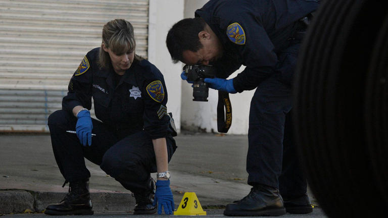 Crime scene investigators with the San Francisco Police Department document the scene of a shooting on Jan. 18, 2011. Getty Images