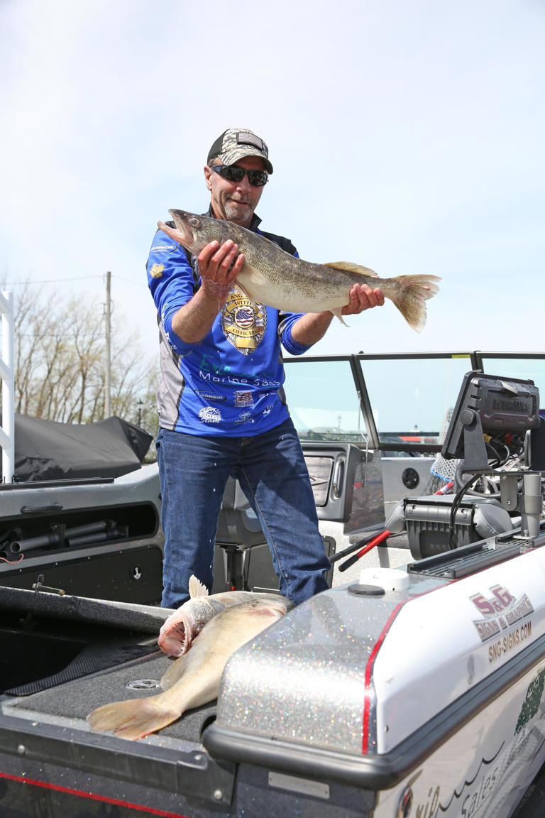 Mercury pro-angler Jack Winters, of Avon Lake, Ohio, shows off a trophy catch on Thursday's first day of the National Walleye Tour in Port Clinton.