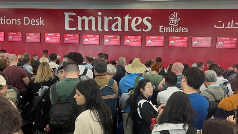 People queue at the flight connection desk at Dubai International Airport the day after a storm swept across the UAE, causing flooding