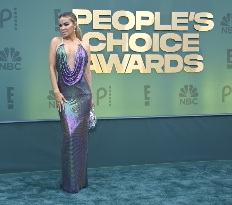 <p>Carmen Electra looked amazing in a plunging mermaid gown at the 2024 People's Choice Awards. Her dress had a halter-style neckline with a structured, bedazzled ring strap, adding extra sparkle to her glamorous look.</p>
