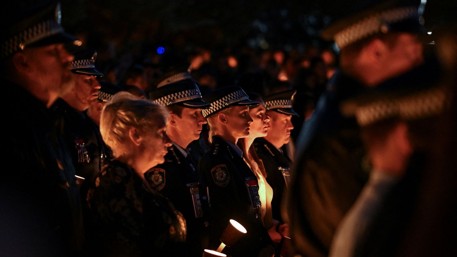mourners gather at candlelight vigil for six killed in sydney mall