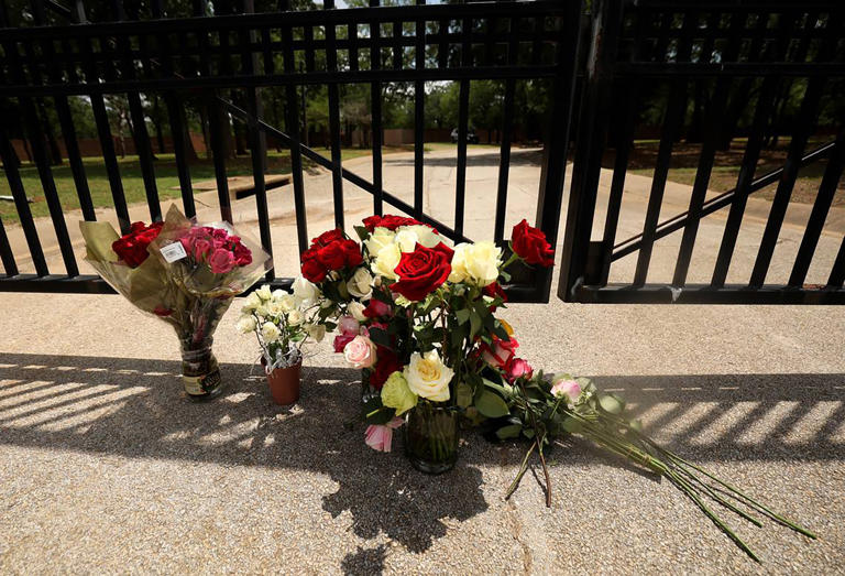 Flowers sit at the gate to the Monastery of the Most Holy Trinity, where the Discalced Carmelite Nuns of Arlington, Texas, live and pray, on Wednesday, May 31, 2023.