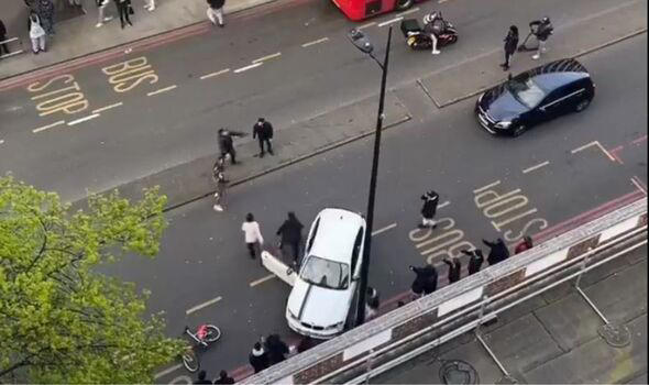 Terrifying moment armed brawl breaks out in middle of street in broad ...