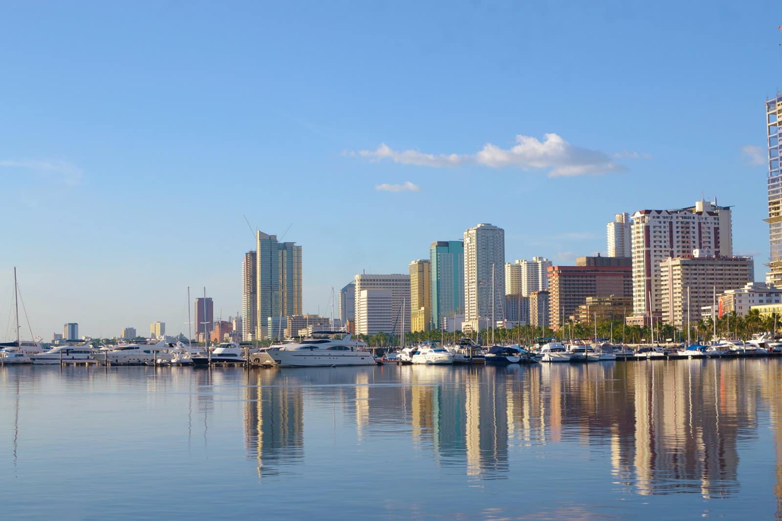 <p class="wp-caption-text">Image Credit: Shutterstock / Jomar Aplaon</p>  <p><span>Roxas Boulevard is a historic waterfront promenade stretching approximately 7.6 kilometers along the shores of Manila Bay. Named after President Manuel Roxas, the boulevard is one of the city’s major arteries, connecting the cultural and entertainment district of Manila with the cities of Pasay and Parañaque to the south. Known for its picturesque sunsets and coconut tree-lined sidewalks, Roxas Boulevard serves as a scenic backdrop for leisure and commerce, embodying the vibrant spirit of the Philippine capital.</span></p> <p><span>A mix of old and new structures, including government offices, embassies, hotels, commercial establishments, and cultural venues flanks the boulevard. Notable landmarks along Roxas Boulevard include the Cultural Center of the Philippines Complex, which houses various arts and performance venues; the historic Manila Hotel; and Rizal Park, one of the largest urban parks in Asia. The area is also popular for outdoor activities, such as jogging, biking, and leisurely walks, especially during the early morning and late afternoon when the Manila Bay sunset creates a breathtaking view.</span></p> <p><span>Over the years, Roxas Boulevard has undergone several redevelopment projects to enhance its role as a key urban space that supports cultural, recreational, and economic activities. Efforts to preserve the beauty of Manila Bay and improve the boulevard’s infrastructure reflect the city’s commitment to maintaining its historical significance while adapting to modern urban demands.</span></p> <p><b>Insider’s Tip: </b><span>Arrive early to secure a spot along the Baywalk for the best sunset views. It’s a popular spot, especially on clear days.</span></p>